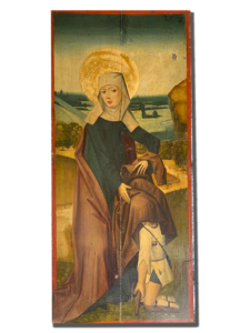 Tableau religieux encadré : sainte assise avec halo doré, robe sombre et manteau brun, paysage au fond