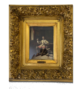 Tableau ancien dans un large cadre doré sculpté, représentant un homme assis en intérieur, tenant un verre, ambiance sombre ; Valais, Suisse.