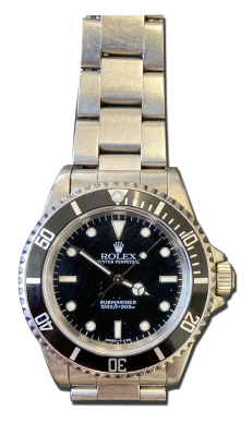 Montre vintage de luxe en acier avec bracelet métal, cadran noir à index lumineux et lunette noire graduée, style plongée.