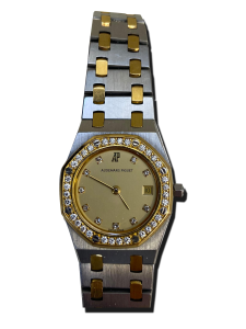 Montre vintage de luxe bicolore acier et or avec bracelet intégré, lunette octogonale sertie de pierres, cadran champagne à index sertis et guichet date ; offre de reprise.