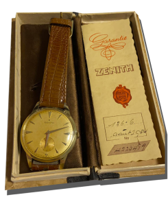 Montre vintage de luxe à cadran doré avec bracelet cuir brun, présentée dans son coffret avec document de garantie ; Rachat