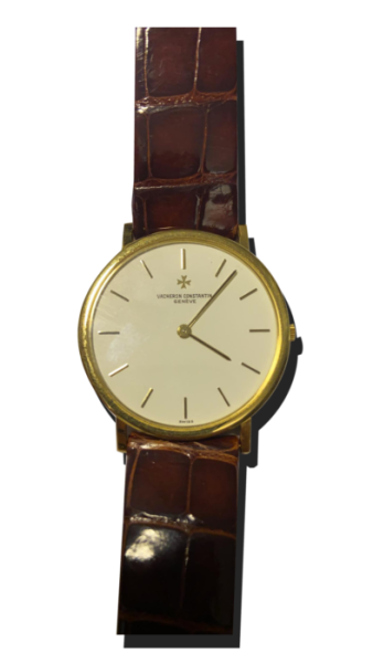 Montre vintage de luxe au style classique : boîtier doré fin, cadran clair épuré avec index bâtons, bracelet cuir brun façon crocodile