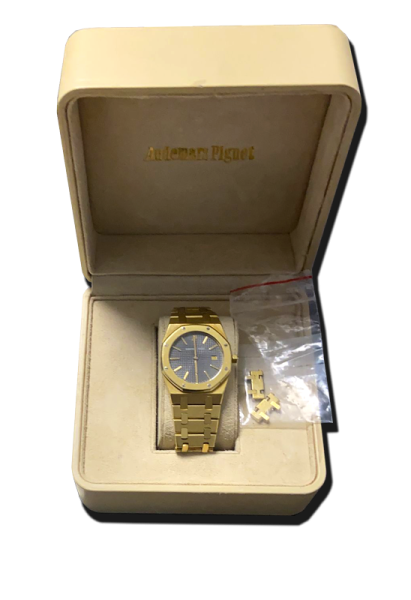 Montre de collection en métal doré, cadran bleu et bracelet intégré, présentée dans son écrin avec maillons supplémentaires